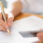 hand with pen credit card application form 1